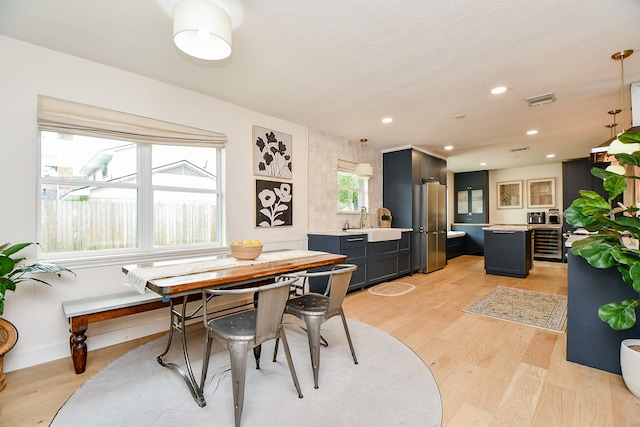 2735 Triway Ln, Houston, TX 77043 - dining room featuring wine cooler, light wood finished floors, recessed lighting, and baseboards