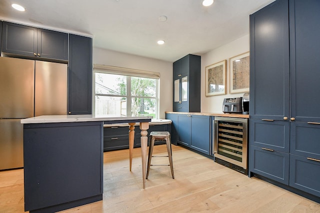 2735 Triway Ln, Houston, TX 77043 - bar area featuring beverage cooler, freestanding refrigerator, recessed lighting, and light wood-type flooring