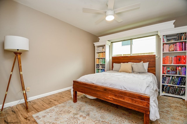 2735 Triway Ln, Houston, TX 77043 - bedroom with wood finished floors, baseboards, and ceiling fan