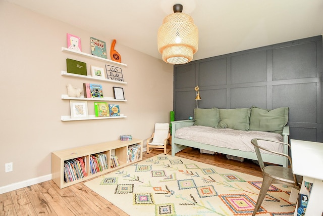 2735 Triway Ln, Houston, TX 77043 - bedroom featuring a decorative wall, wood finished floors, and baseboards
