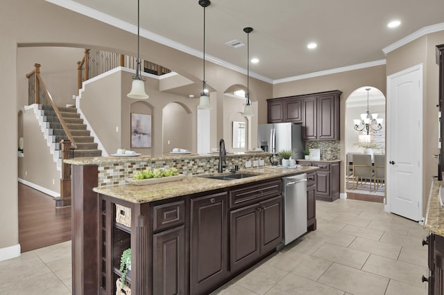 13518 Ambler Springs Dr, Tomball, TX 77377 - kitchen with stainless steel appliances, a sink, arched walkways, an island with sink, and recessed lighting