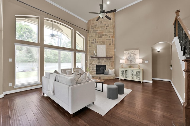 13518 Ambler Springs Dr, Tomball, TX 77377 - living area with crown molding, a ceiling fan, healthy amount of natural light, a fireplace, and arched walkways
