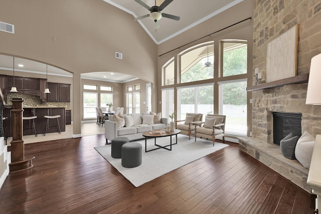 13518 Ambler Springs Dr, Tomball, TX 77377 - living area featuring arched walkways, ceiling fan, high vaulted ceiling, crown molding, and dark wood-type flooring
