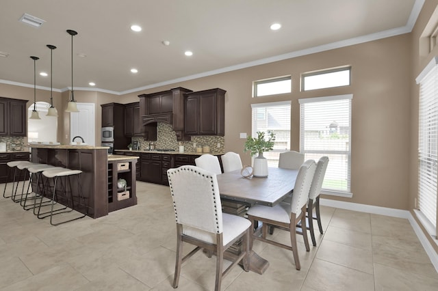 13518 Ambler Springs Dr, Tomball, TX 77377 - dining room with ornamental molding, plenty of natural light, recessed lighting, light tile patterned floors, and baseboards
