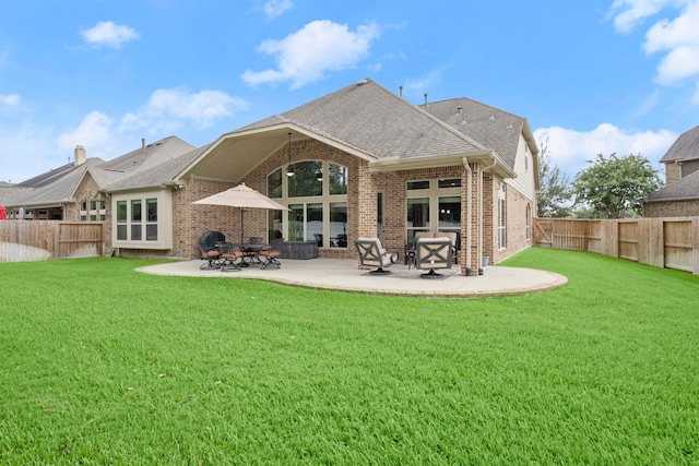 13518 Ambler Springs Dr, Tomball, TX 77377 - back of house with brick siding, a patio area, and roof with shingles