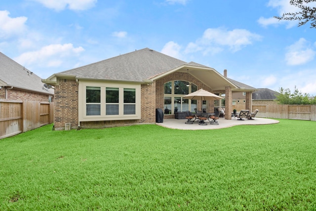13518 Ambler Springs Dr, Tomball, TX 77377 - rear view of property with brick siding, a shingled roof, and a patio area