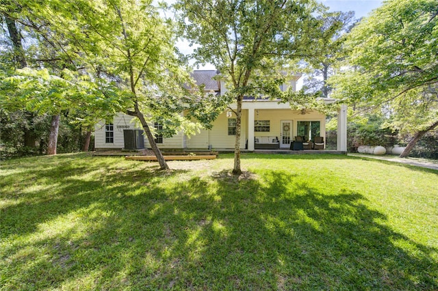 25903 Penguin St, Magnolia, TX 77355 - back of house with a lawn and cooling unit