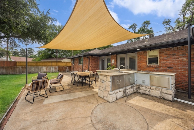 10228 Brinwood Dr, Houston, TX 77043 - view of patio featuring an outdoor kitchen and a sink