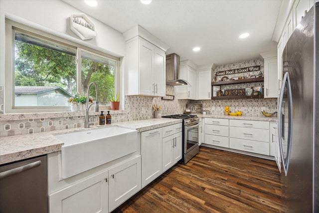 10228 Brinwood Dr, Houston, TX 77043 - kitchen with appliances with stainless steel finishes, wall chimney exhaust hood, a sink, open shelves, and plenty of natural light