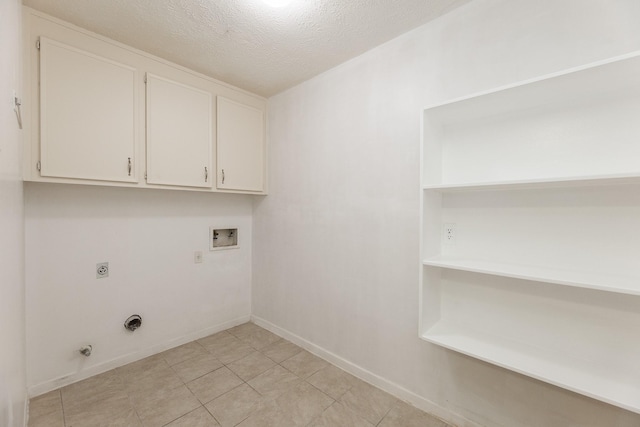 2543 Sage Brush Ln, Sugar Land, TX 77479 - laundry area with electric dryer hookup, cabinet space, hookup for a washing machine, baseboards, and a textured ceiling