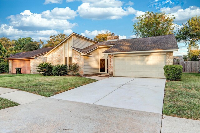 2543 Sage Brush Ln, Sugar Land, TX 77479 - mid-century inspired home featuring driveway, an attached garage, a chimney, and stone siding