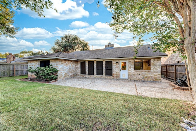 2543 Sage Brush Ln, Sugar Land, TX 77479 - back of property featuring stone siding, a patio, a chimney, and a shingled roof