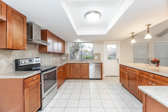 2543 Sage Brush Ln, Sugar Land, TX 77479 - kitchen featuring stainless steel appliances, wall chimney exhaust hood, a sink, decorative backsplash, and brown cabinets