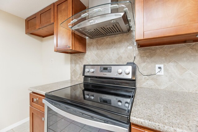 2543 Sage Brush Ln, Sugar Land, TX 77479 - kitchen featuring stainless steel range with electric cooktop, extractor fan, brown cabinetry, light countertops, and backsplash
