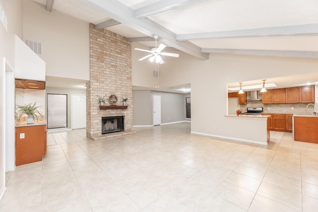 2543 Sage Brush Ln, Sugar Land, TX 77479 - unfurnished living room with a sink, ceiling fan, a fireplace, beamed ceiling, and high vaulted ceiling