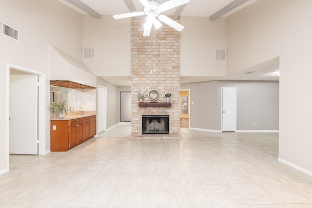 2543 Sage Brush Ln, Sugar Land, TX 77479 - unfurnished living room with high vaulted ceiling, a ceiling fan, a fireplace, beam ceiling, and light tile patterned floors