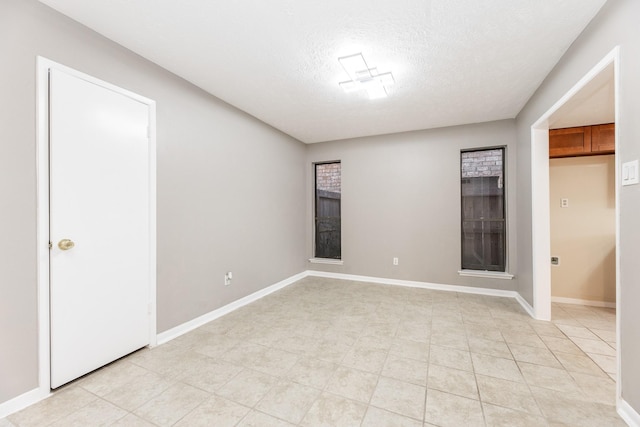 2543 Sage Brush Ln, Sugar Land, TX 77479 - unfurnished bedroom featuring baseboards and a textured ceiling