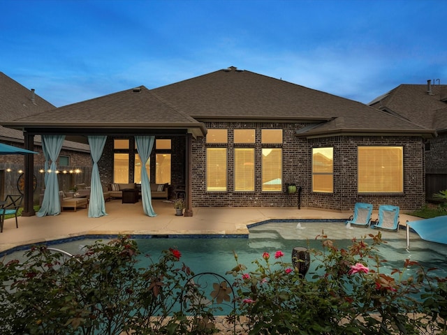 2314 Navo Ln, League City, TX 77573 - back of house with roof with shingles, brick siding, a patio area, and outdoor lounge area