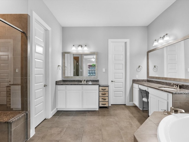 2314 Navo Ln, League City, TX 77573 - bathroom with a stall shower, two vanities, a bath, tile patterned flooring, and baseboards