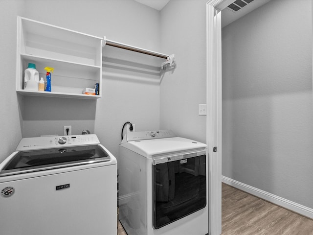 2314 Navo Ln, League City, TX 77573 - laundry room with independent washer and dryer, wood finished floors, and baseboards