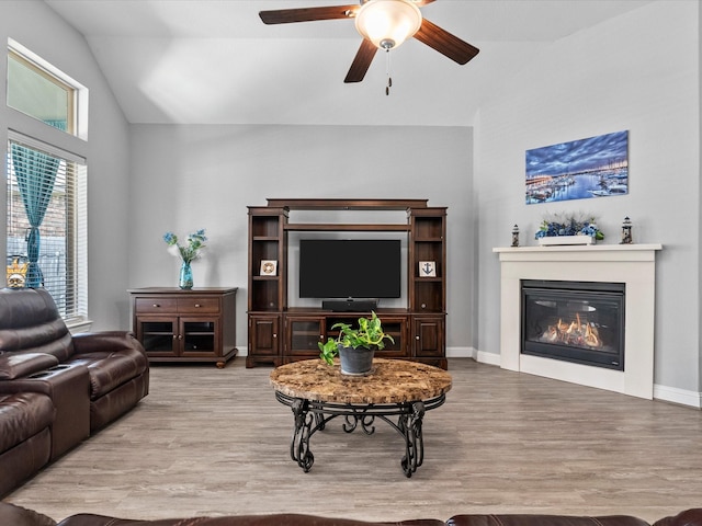 2314 Navo Ln, League City, TX 77573 - living area with wood finished floors, high vaulted ceiling, a ceiling fan, and a glass covered fireplace