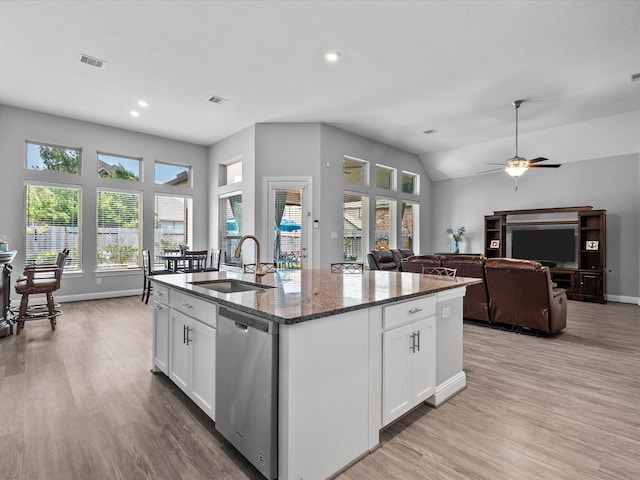 2314 Navo Ln, League City, TX 77573 - kitchen with stainless steel dishwasher, a sink, light wood finished floors, dark stone counters, and recessed lighting