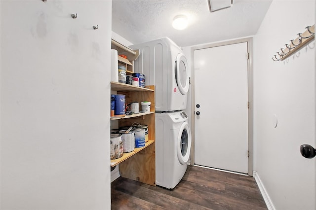 3218 Barkers Forest Ln, Houston, TX 77084 - washroom featuring estacked washer and dryer, dark wood finished floors, a textured ceiling, and baseboards