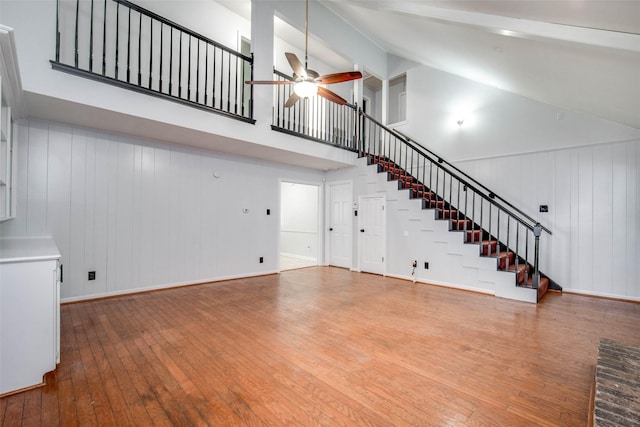 15319 Paseo Del Rey Dr, Houston, TX 77083 - unfurnished living room with ceiling fan, hardwood / wood-style flooring, stairs, high vaulted ceiling, and beamed ceiling