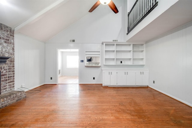 15319 Paseo Del Rey Dr, Houston, TX 77083 - unfurnished living room with ceiling fan, high vaulted ceiling, light wood-style flooring, a fireplace, and beamed ceiling
