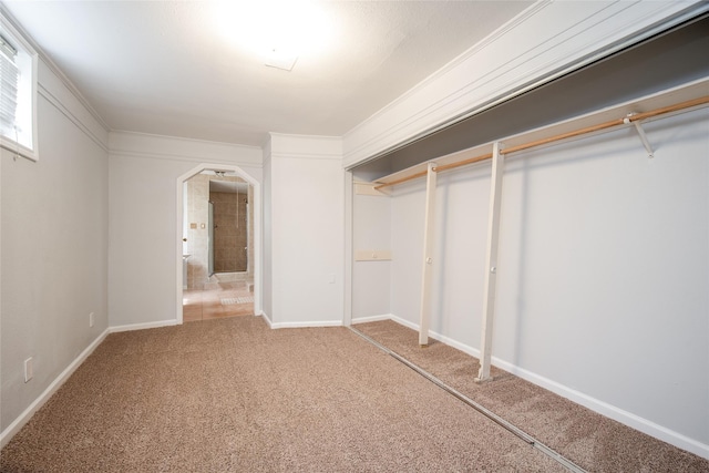 15319 Paseo Del Rey Dr, Houston, TX 77083 - unfurnished bedroom with carpet flooring, arched walkways, and baseboards