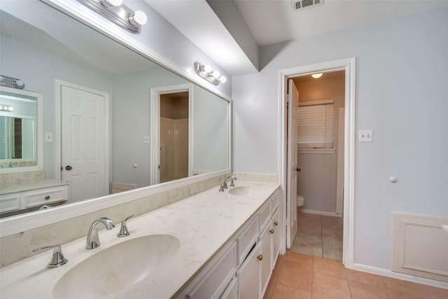 15319 Paseo Del Rey Dr, Houston, TX 77083 - full bath featuring toilet, double vanity, tile patterned floors, and baseboards