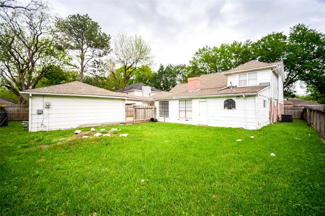 15319 Paseo Del Rey Dr, Houston, TX 77083 - rear view of house with central air condition unit and a chimney