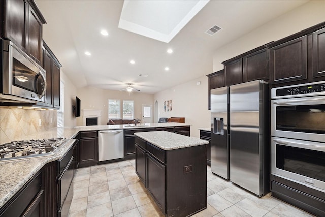 3707 Daintree Park Dr, Katy, TX 77494 - kitchen featuring stainless steel appliances, backsplash, a peninsula, recessed lighting, and a kitchen island