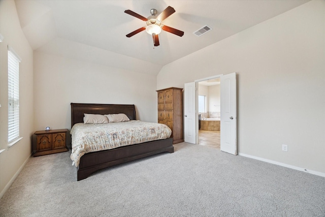3707 Daintree Park Dr, Katy, TX 77494 - carpeted bedroom featuring multiple windows, lofted ceiling, baseboards, and ensuite bathroom