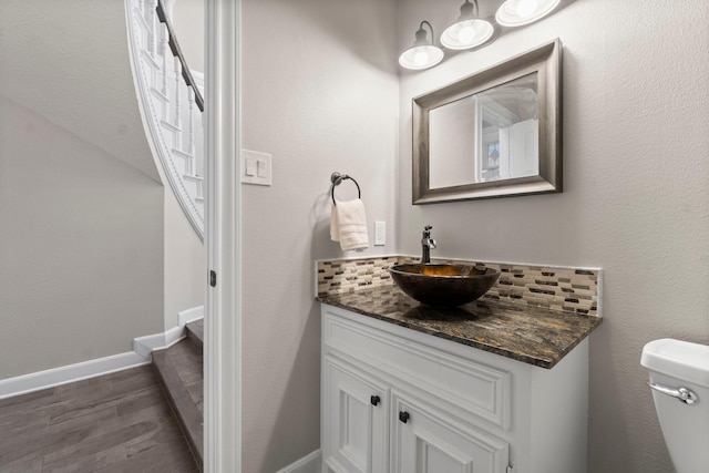 11407 Squiredale Dr, Houston, TX 77070 - half bathroom with wood finished floors, vanity, toilet, and baseboards