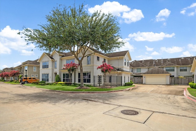 4319 Stonebrook Ln, Missouri City, TX 77459 - townhome / multi-family property with a garage, a residential view, stucco siding, and concrete driveway