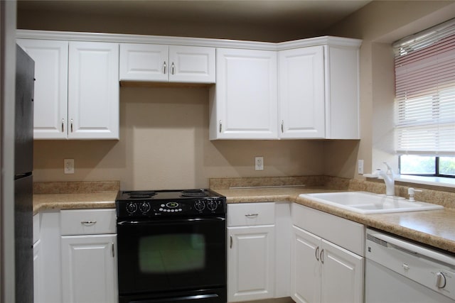 10001 Westpark Dr Unit 25, Houston, TX 77042 - kitchen featuring black appliances, a sink, white cabinets, and light countertops