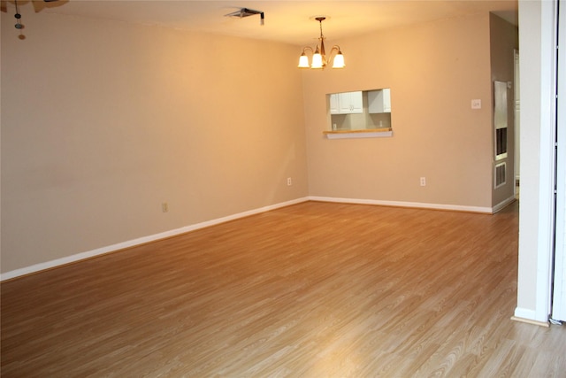 10001 Westpark Dr Unit 25, Houston, TX 77042 - spare room with light wood-style floors, a chandelier, and baseboards