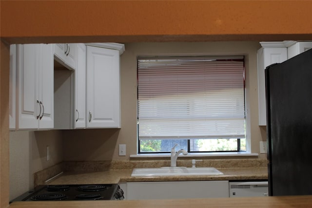 10001 Westpark Dr Unit 25, Houston, TX 77042 - kitchen featuring a sink, black appliances, healthy amount of natural light, and white cabinetry