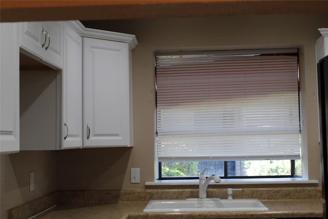 10001 Westpark Dr Unit 25, Houston, TX 77042 - kitchen view of a sink and white cabinetry