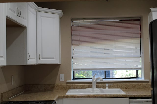 10001 Westpark Dr Unit 25, Houston, TX 77042 - kitchen with a sink, white cabinetry, and dishwasher