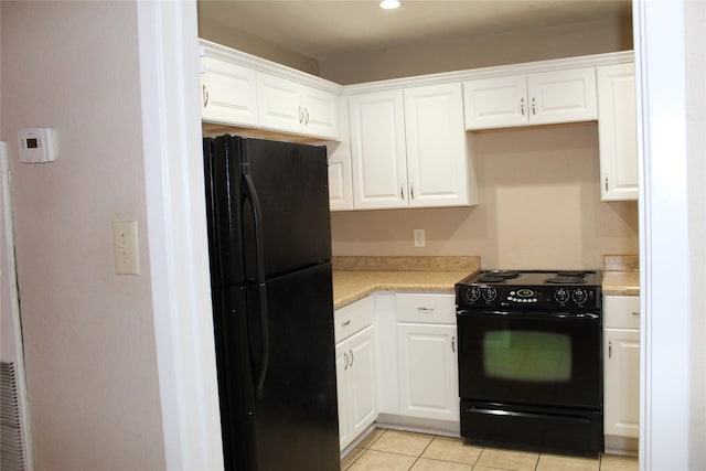 10001 Westpark Dr Unit 25, Houston, TX 77042 - kitchen with black appliances, light countertops, white cabinetry, and recessed lighting