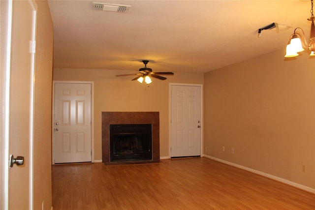 10001 Westpark Dr Unit 25, Houston, TX 77042 - unfurnished living room featuring wood finished floors, a ceiling fan, baseboards, and a fireplace
