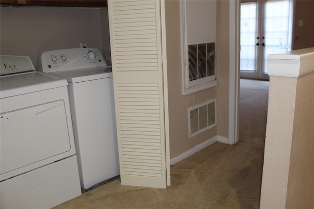 10001 Westpark Dr Unit 25, Houston, TX 77042 - washroom featuring light carpet, washer and dryer, and baseboards