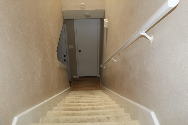 10001 Westpark Dr Unit 25, Houston, TX 77042 - stairs featuring wood finished floors and a textured wall