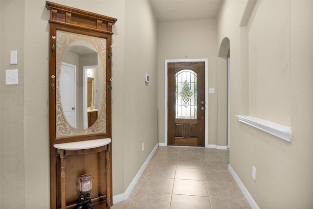 2602 Tacoma Springs Dr, Conroe, TX 77304 - foyer entrance featuring arched walkways, tile patterned floors, and baseboards