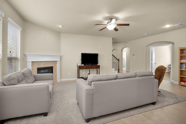2602 Tacoma Springs Dr, Conroe, TX 77304 - living room with arched walkways, a ceiling fan, a fireplace, light tile patterned floors, and recessed lighting