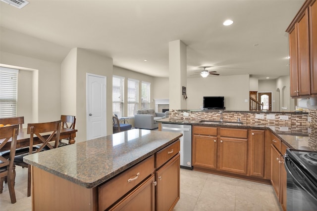 2602 Tacoma Springs Dr, Conroe, TX 77304 - kitchen featuring dishwasher, a sink, open floor plan, a ceiling fan, and decorative backsplash