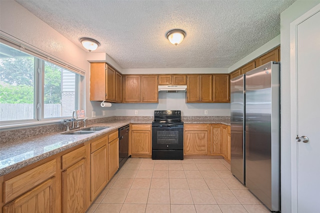 1806 Foxlake Dr, Houston, TX 77084 - kitchen featuring black appliances, under cabinet range hood, a textured ceiling, light tile patterned floors, and a sink