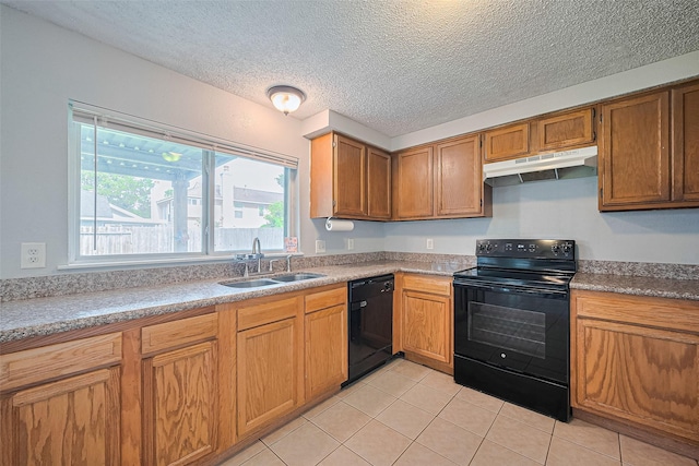 1806 Foxlake Dr, Houston, TX 77084 - kitchen with under cabinet range hood, black appliances, a sink, light tile patterned flooring, and a textured ceiling
